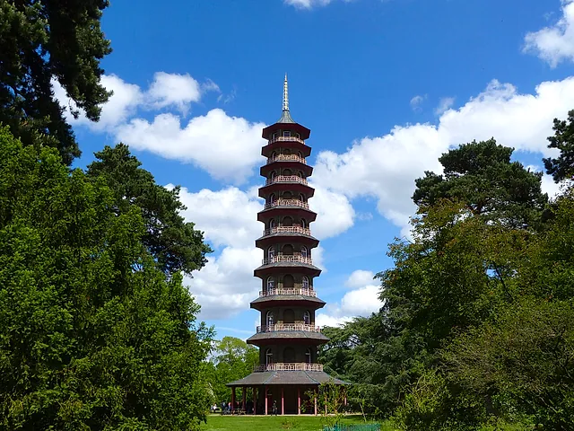 The ten-storey Great Pagoda rising above the trees against a blue sky with white clouds